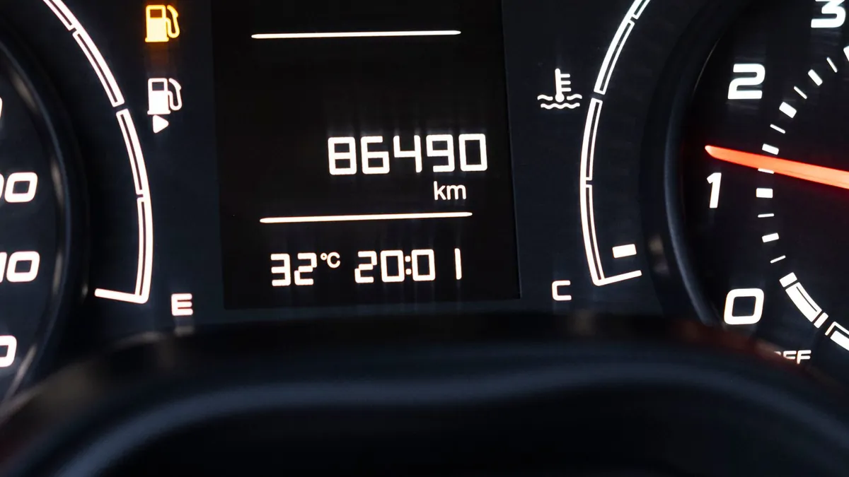 A car's digital odometer reading 86,490 km